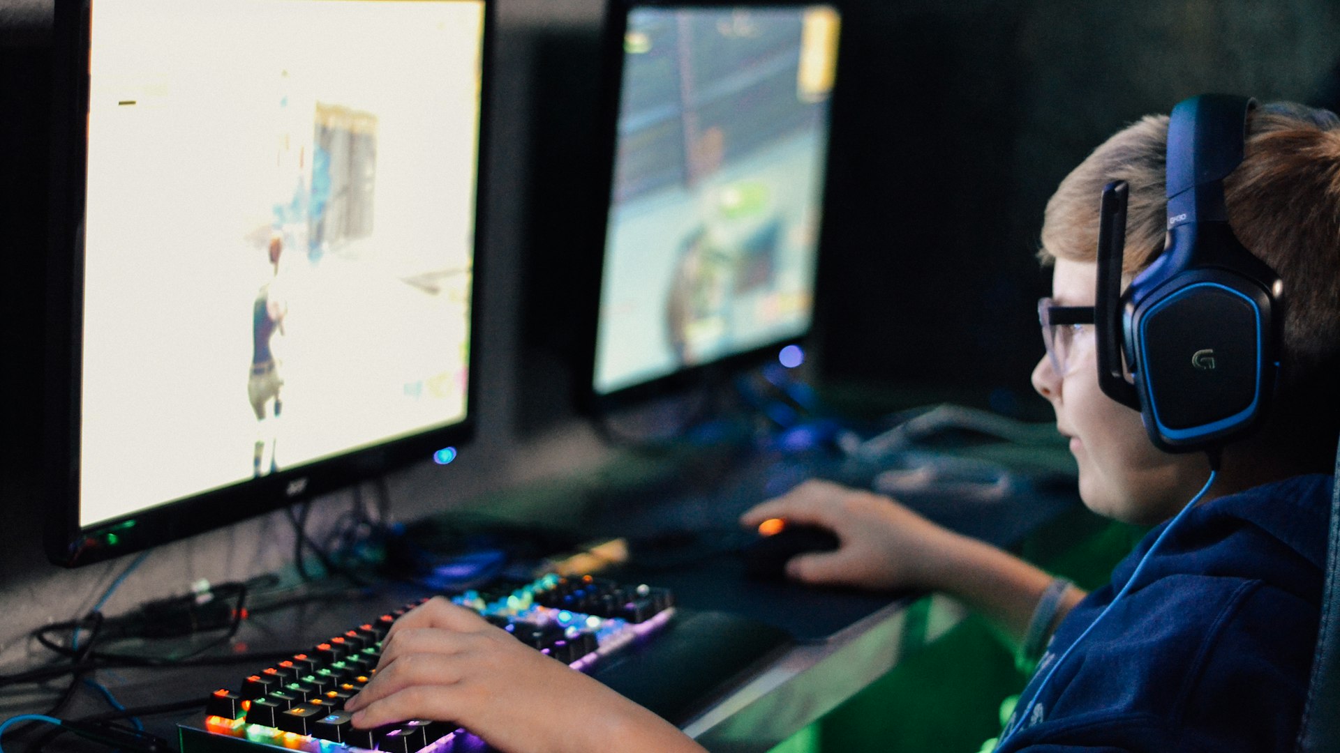 Gamer at a neon-lit desk mid-session